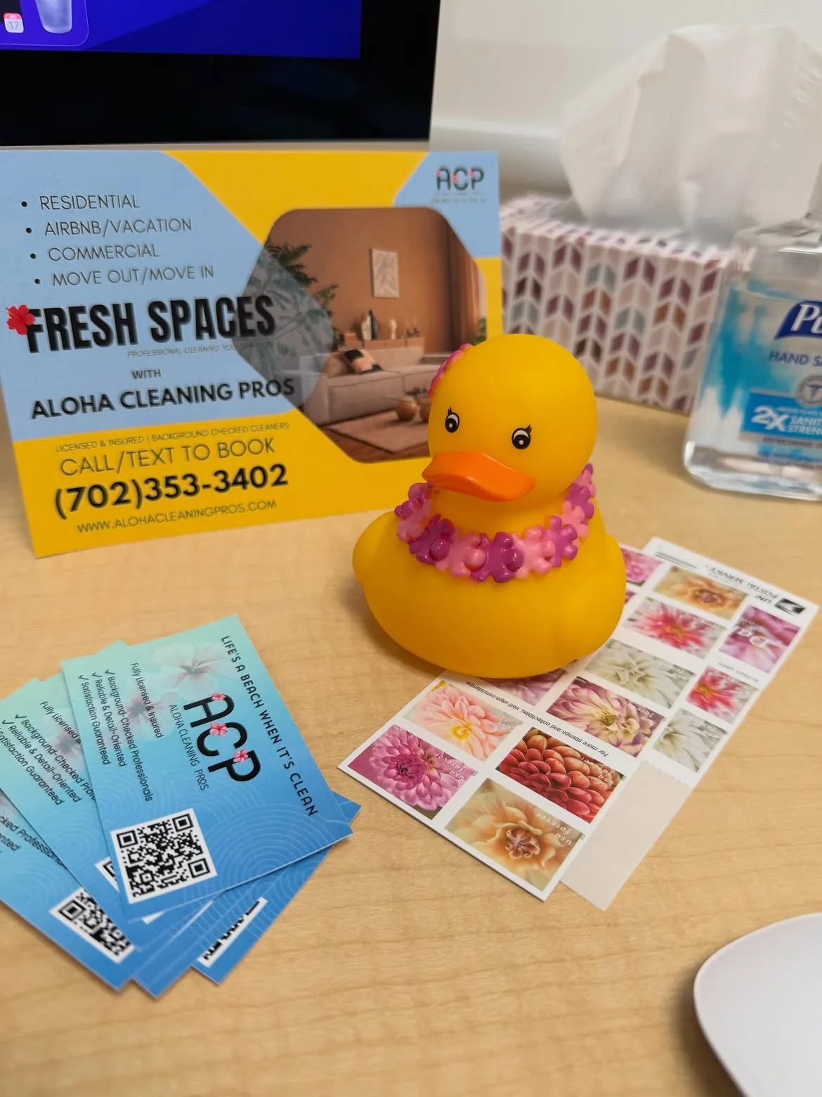 Aloha Cleaning Pros marketing materials and yellow rubber duck on wooden desk